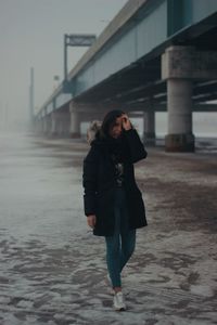 Woman standing in city in winter