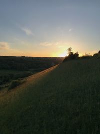 Scenic view of field against sky during sunset