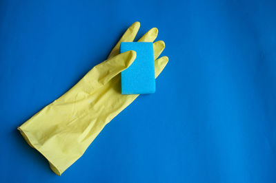 High angle view of glove and sponge on table