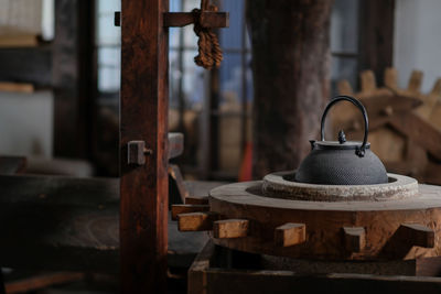 Wooden gears and teapot in factory