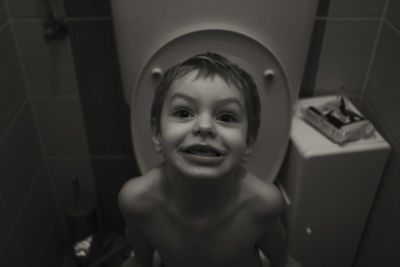 Portrait of shirtless boy in bathroom
