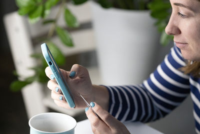 Midsection of woman using mobile phone