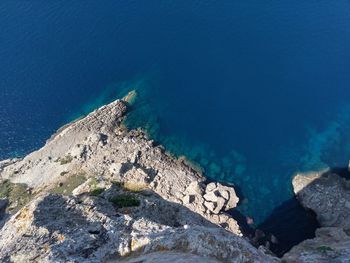 High angle view of rocks by sea