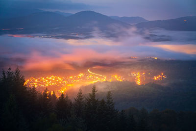 On the edge of an inversion in the black forest, the golden lights of a village light up the night