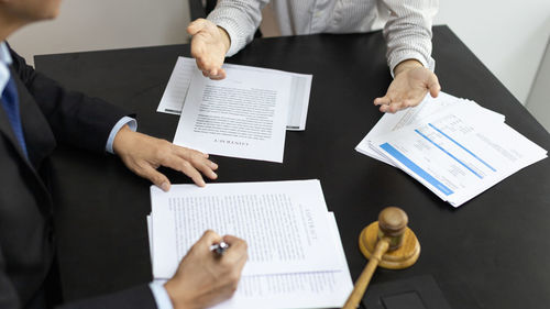 Midsection of business colleagues working in office