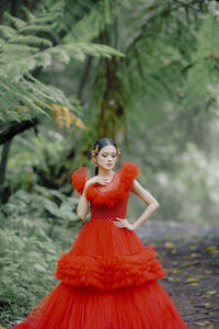 Young woman standing on footpath