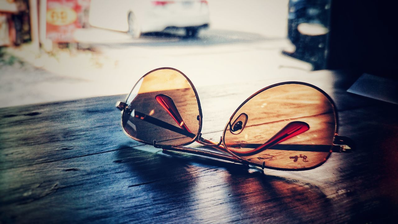CLOSE-UP OF SUNGLASSES ON TABLE AT HOME DURING MONSOON