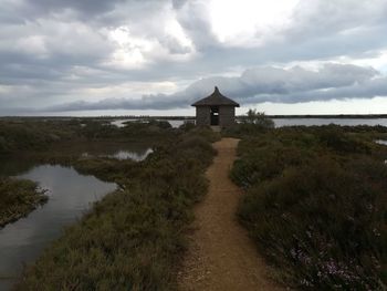 Scenic view of building by sea against sky