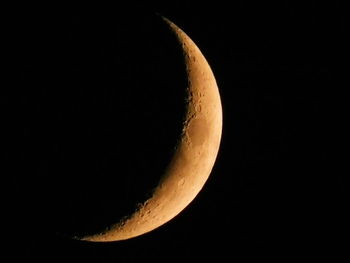 Low angle view of half moon against sky at night