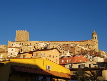 Low angle view of buildings against blue sky