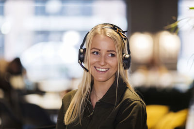 Woman wearing headset in office