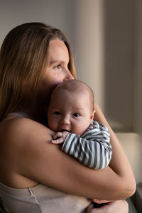 Side view of mother and daughter at home