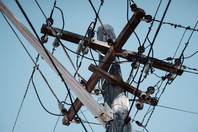 Low angle view of electricity pylon against sky