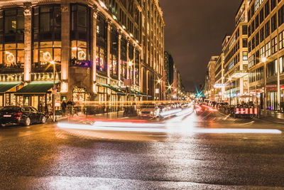 Illuminated city street at night