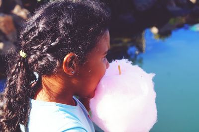 Close-up of girl eating cotton candy
