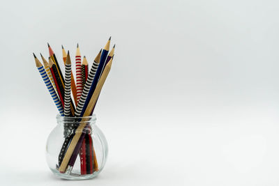 Close-up of multi colored pencils against white background