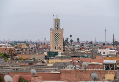 Skyline of medina with mosque minaret and atlas mountain far behind