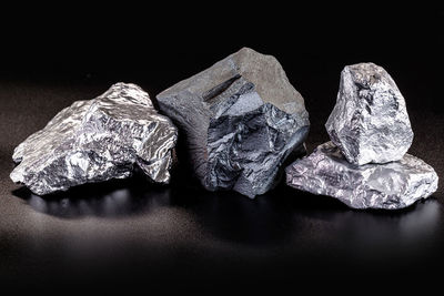 Close-up of stones on rock against black background