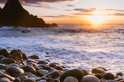 Scenic view of sea against sky at sunset