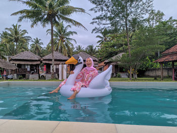 Portrait of woman swimming in pool