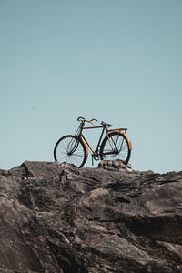 Minimalist photo of a bicycle on a rock