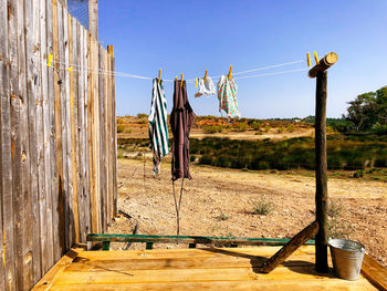 Clothes drying on wooden post against clear sky