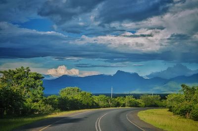 Road amidst landscape against sky