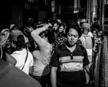 Rear view of people standing on street