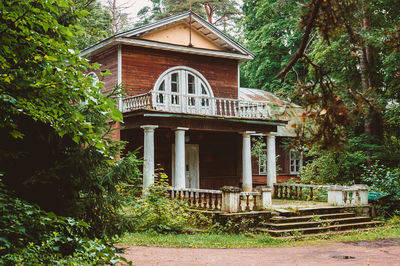 Exterior of house by building in forest