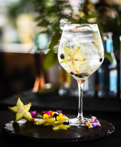 Tonic gin beverage with fresh fruits and spices