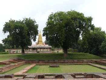 Trees in temple against sky