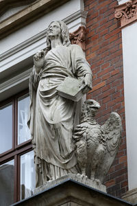 Low angle view of statue against built structure