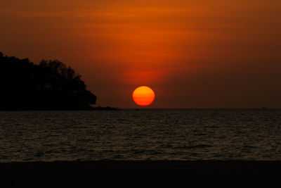 Scenic view of sea against orange sky