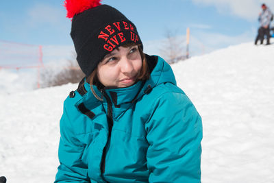 Woman wearing winter clothing in snowy mountain