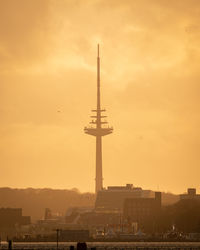 Low angle view of tower against sky during sunset