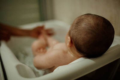 Rear view of baby boy in bathroom