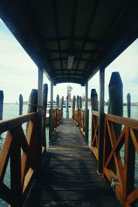 Narrow pathway along bridge over sea in city