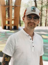 Portrait of young man wearing sunglasses standing outdoors