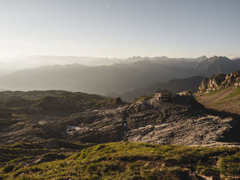 View of house on landscape against mountain range