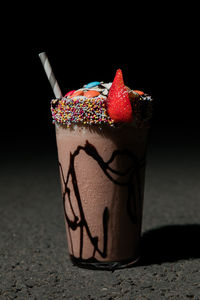 Close-up of ice cream cone against black background