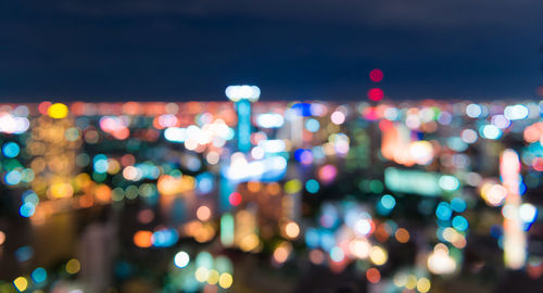 Defocused image of illuminated city at night