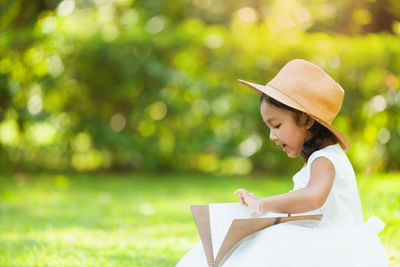 Side view of woman reading book