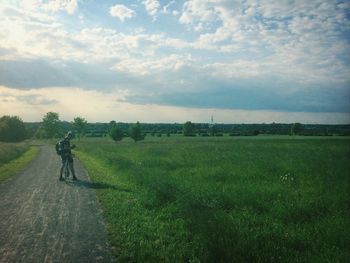 People walking on grassy field