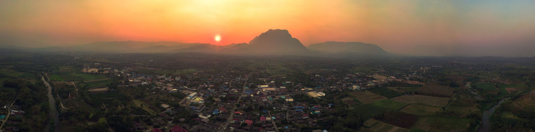 Aerial view of townscape against sky during sunset
