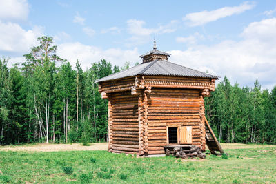 An ancient wooden prison in a forest glade in siberia. historical life