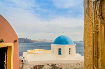 View of sea and buildings against sky