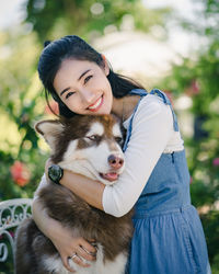 Portrait of smiling woman with dog