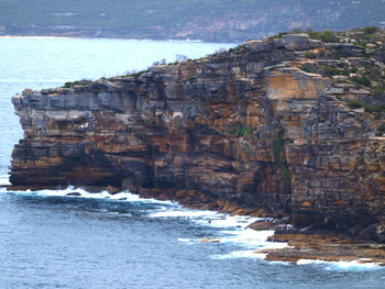 Scenic view of sea by cliff