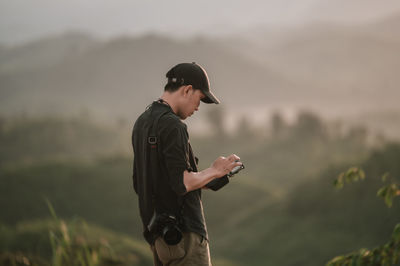 Side view of man standing on field