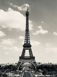 Tower of building against cloudy sky